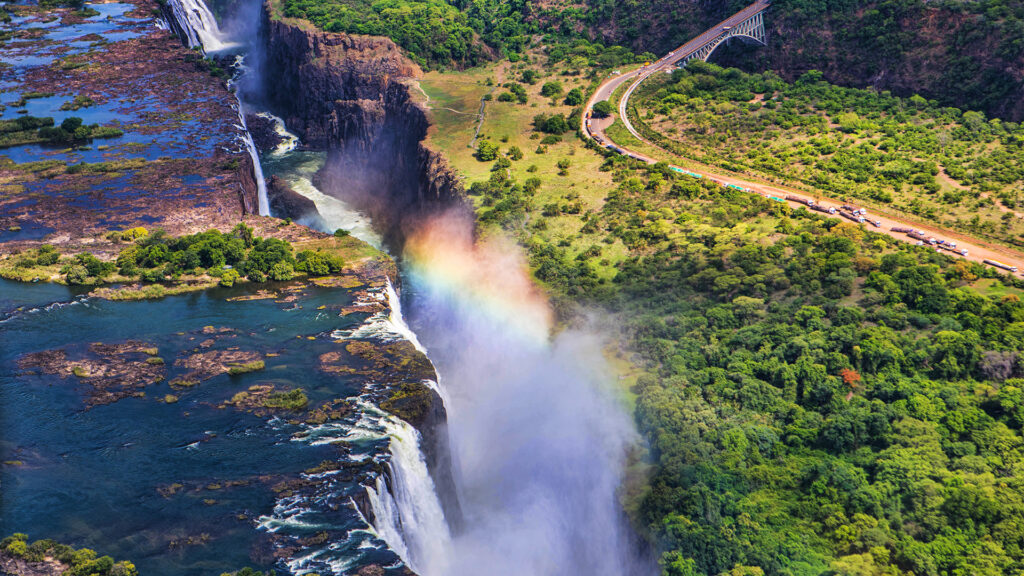 Rainbow,Over,Victoria,Falls,In,Zimbabwe,,Sunny,Day,In,Africa